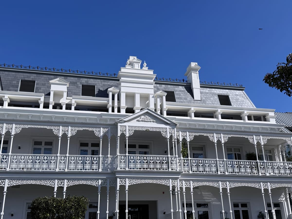 Slate mansard roof, dormers and chimney along the hotel frontage