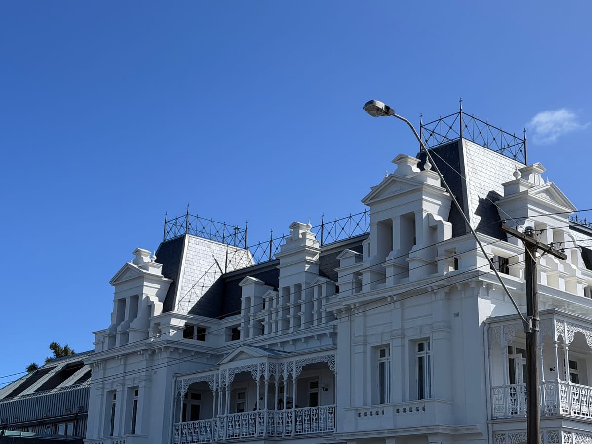 Corner tower of the Beaumaris Hotel with slate roof and iron cresting