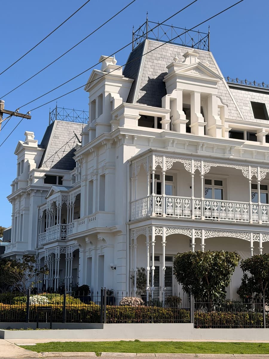 Corner of the Beaumaris Hotel with slate roofs above two levels of verandah
